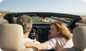 Couple in a convertible on a road