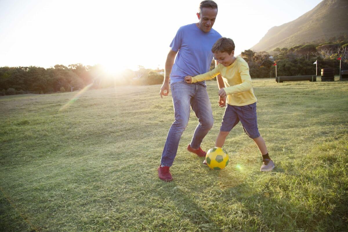 Father and Son Playing Soccer